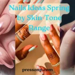 "A four-panel collage showcasing spring nail ideas for various skin tones. The top left features rose gold chrome almond nails; the top right shows deep plum nails with a floral accent; the bottom panels display vibrant peach and mint green geometric and floral art on deeper skin tones. Centered blue text reads 'Nails Ideas Spring by Skin-Tone Range' with the pressonp.com watermark at the bottom."