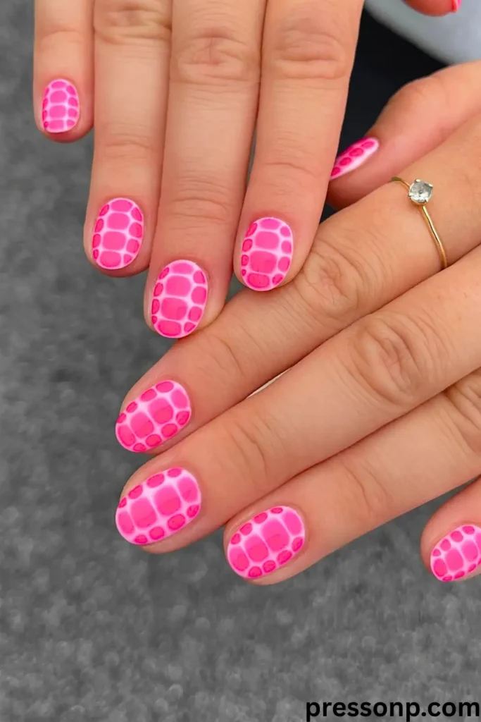 A close-up of a hand with short, round-oval nails featuring a soft nude-pink base decorated with a minimalist design of silver micro-glitter and delicate white line accents.