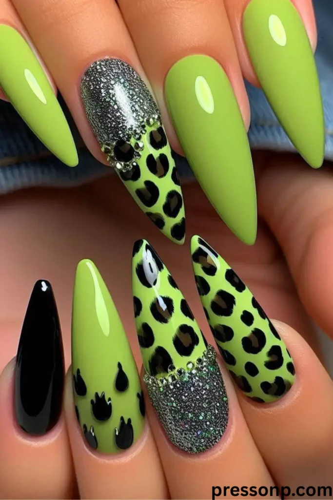 A close-up of long, refined almond-shaped nails featuring a high-gloss sheer nude base coat decorated with minimalist, abstract squiggly lines in a vibrant neon lime green lacquer.