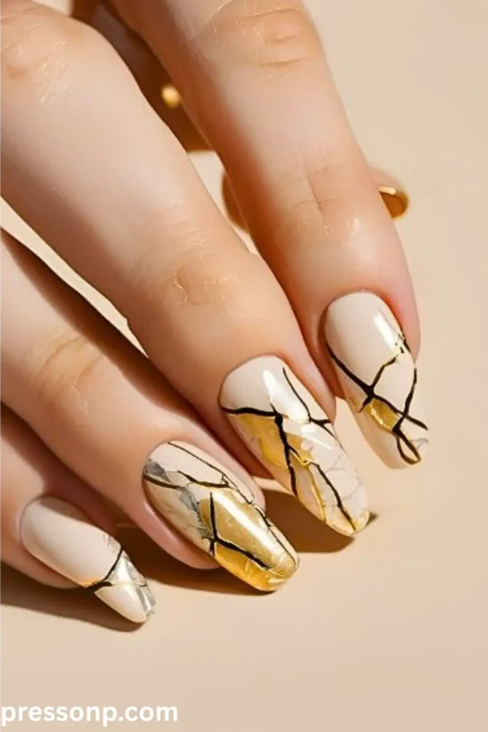 creamy off-white base decorated with an abstract kintsugi-style design of fractured black lines and shimmering metallic gold foil accents.