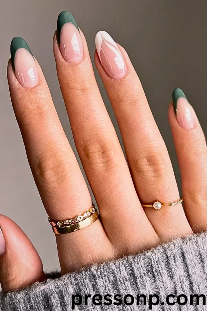 "Short almond-shaped nails featuring a modern tropical French tip design. The manicure uses a natural nude base with deep forest green tips on most fingers and a unique white abstract double-arch design on the ring finger. A pink 'pressonp.com' watermark is visible at the bottom."