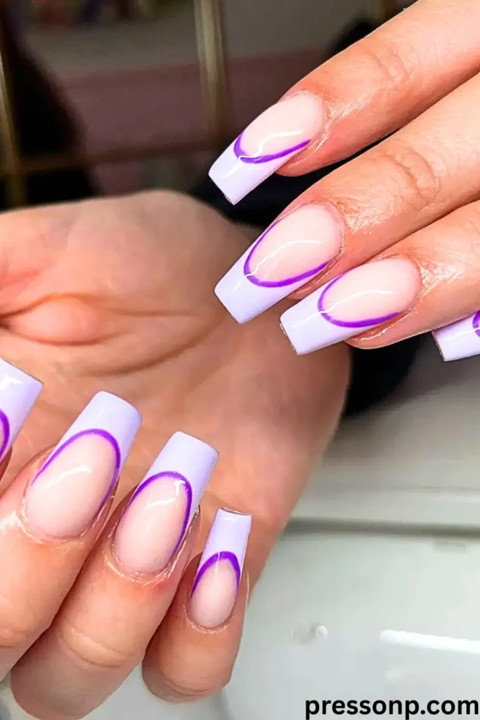 A close-up of long, square-shaped press-on nails featuring a lavender reverse French manicure, highlighted by a thin, vibrant neon purple line framing the cuticle beds.