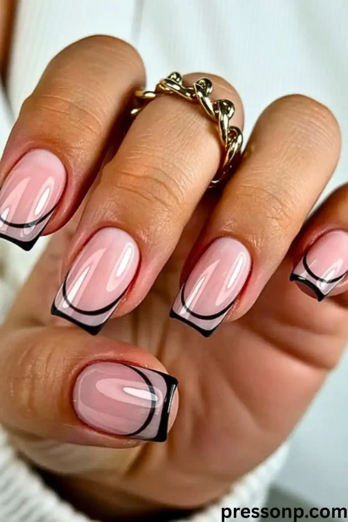 A close-up of long, square-shaped nails featuring a "Negative Space French" manicure with a glossy nude base outlined by a sharp, minimalist black frame.