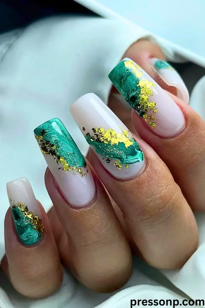 A close-up of long, square-shaped nails featuring a "Mint Green with Gold Flakes" design with jade-like marble swirls and metallic gold foil over a milky white base.