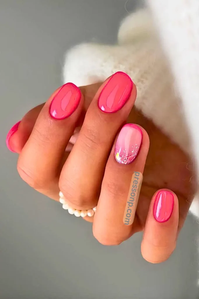 A close-up of hands displaying a vibrant, high-gloss neon pink manicure on neatly shaped, short square nails.