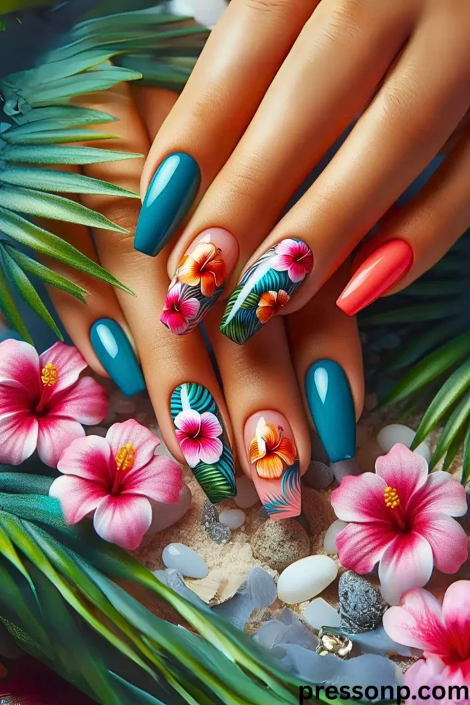 A close-up of a vibrant tropical manicure featuring long, square-coffin nails in deep teal and bright coral, paired with detailed accent nails showcasing hand-painted pink and orange hibiscus flowers and lush palm leaves.