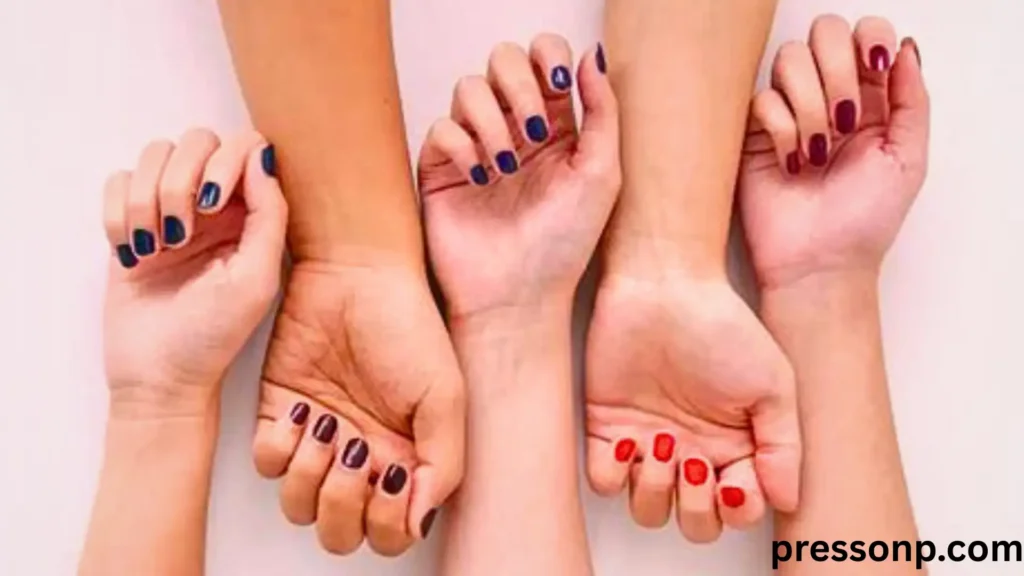 "Five different forearms and hands displayed side-by-side to demonstrate skin undertone testing. The image shows a range of skin tones from fair to deep, highlighting how various nail colors like navy, burgundy, and bright red interact with different complexions. This visual aids in identifying cool, warm, and neutral undertones through vein comparison. Watermarked with pressonp.com."