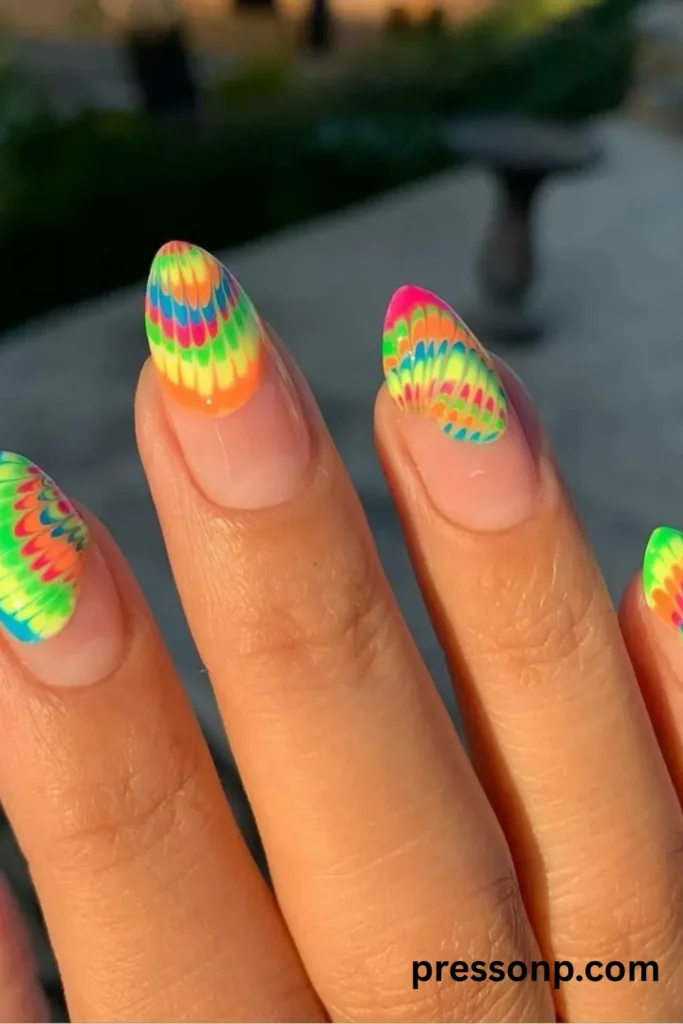 Almond-shaped clear nails featuring a retro neon multi-colored tie-dye water marble design on the tips.