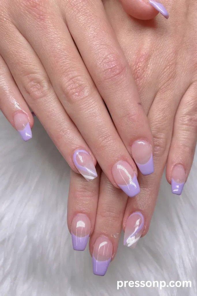 Close-up of medium-length coffin nails with a sheer nude base, featuring crisp lavender French tips mixed with wavy abstract swirl accent nails in purple and white.