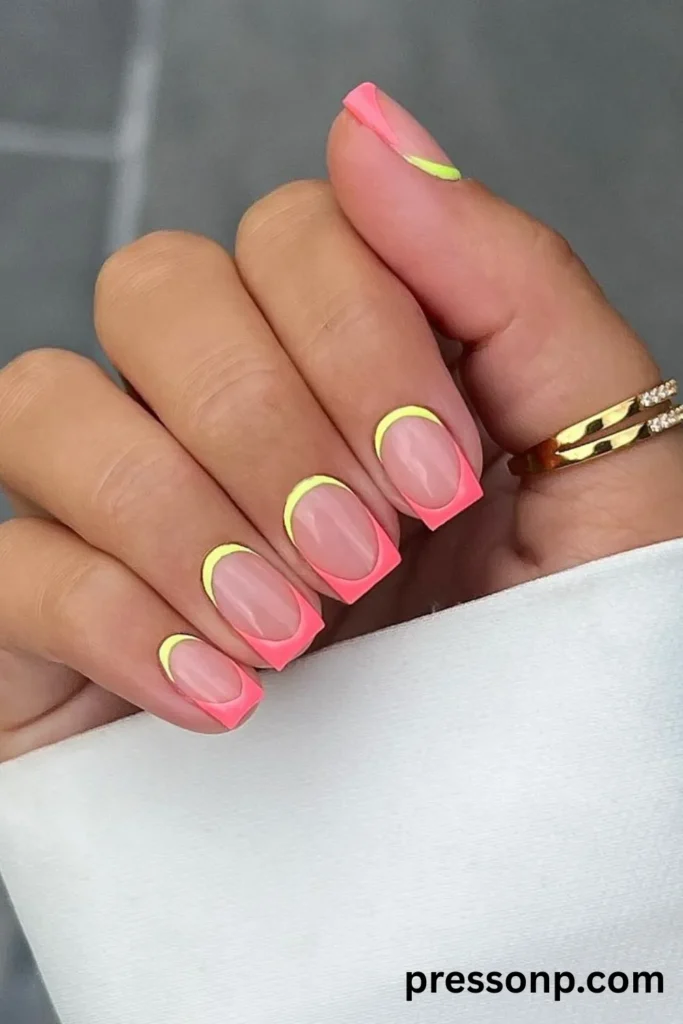 Close-up of medium-length, square-edge manicured nails featuring vibrant neon pink French tips and a contrasting neon yellow outline along the cuticles.