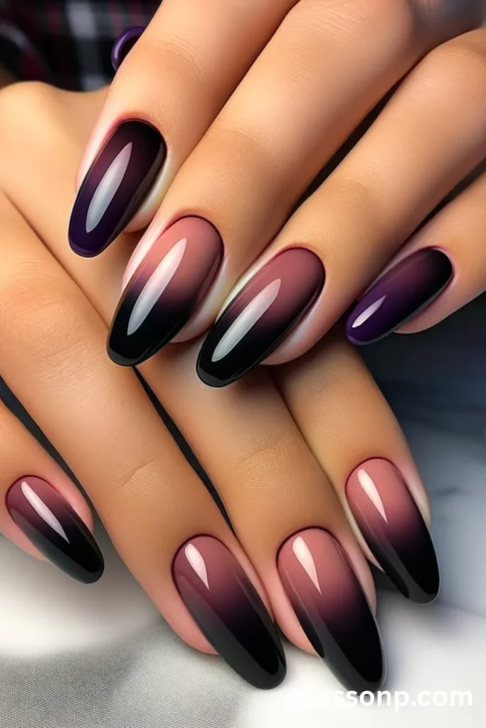 Close-up of long, glossy oval nails featuring a smooth ombré gradient that transitions from a muted neon mauve-purple base into deep, abstract black tips.