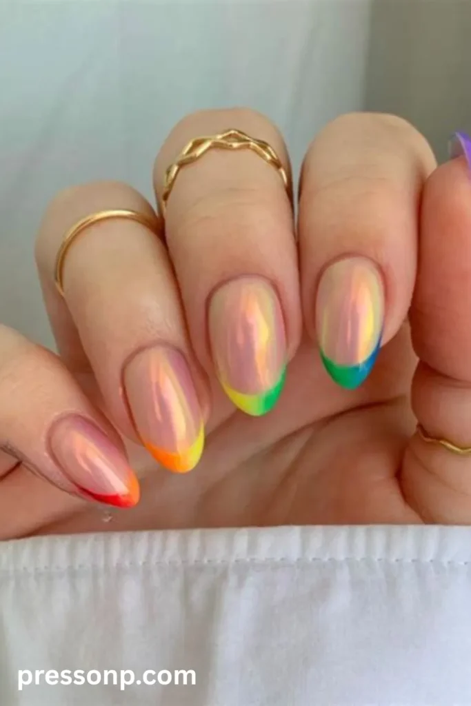 Close-up of medium almond-shaped nails featuring a shimmering, iridescent glazed chrome base paired with colorful French tips that form a seamless rainbow ombré progression across the fingers.