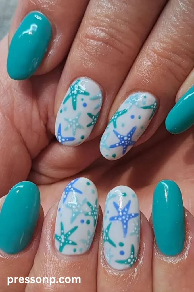 Close-up of oval nails featuring bright turquoise solid color mixed with white accent nails decorated with hand-painted starfish in various shades of blue and teal.